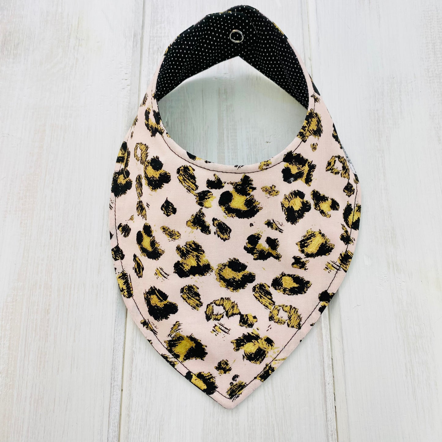 Blush cheetah print bandana bib with gold accents, animal print, reversible and waterproof bib