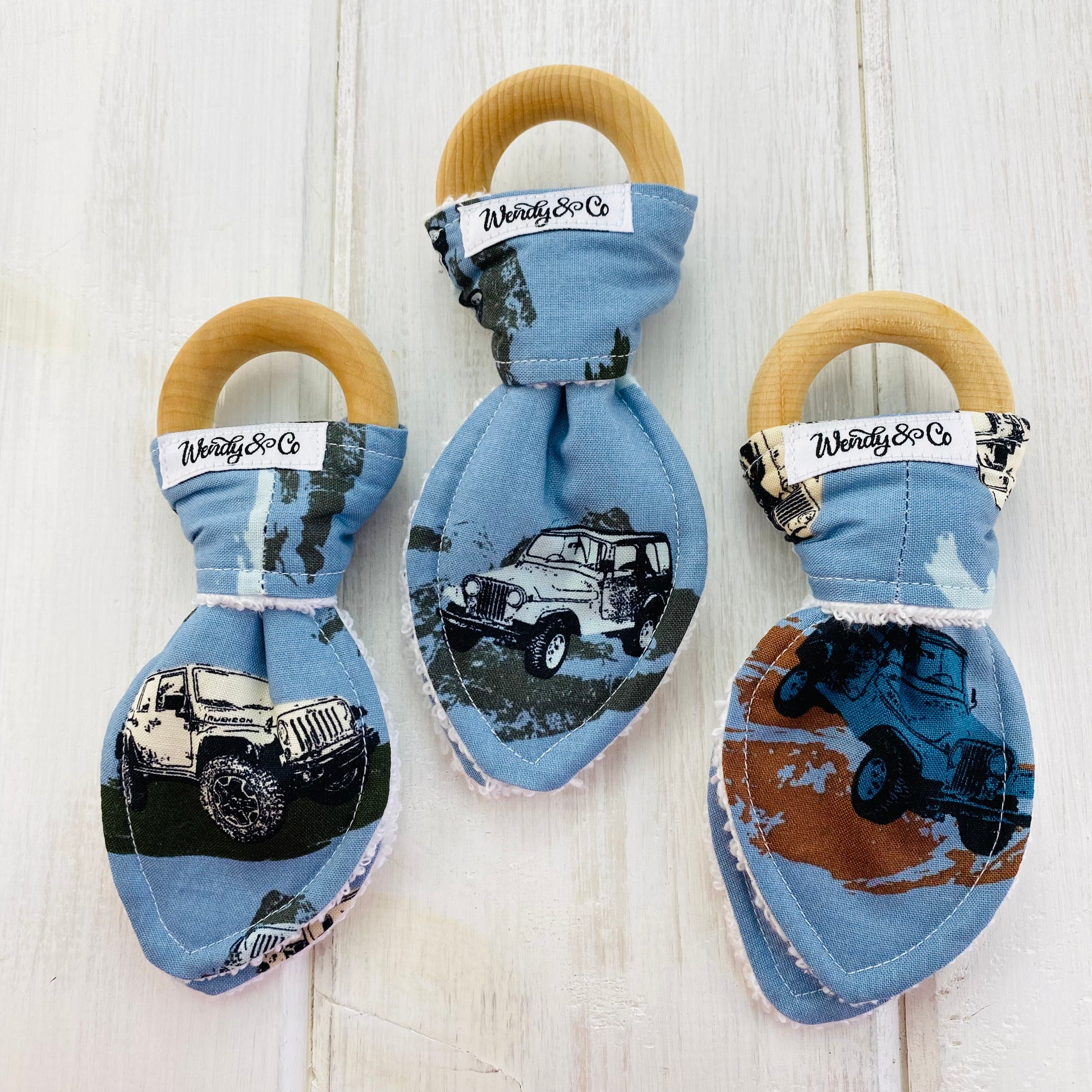 Baby teether organic with 4-wheeling jeeps with blue background.