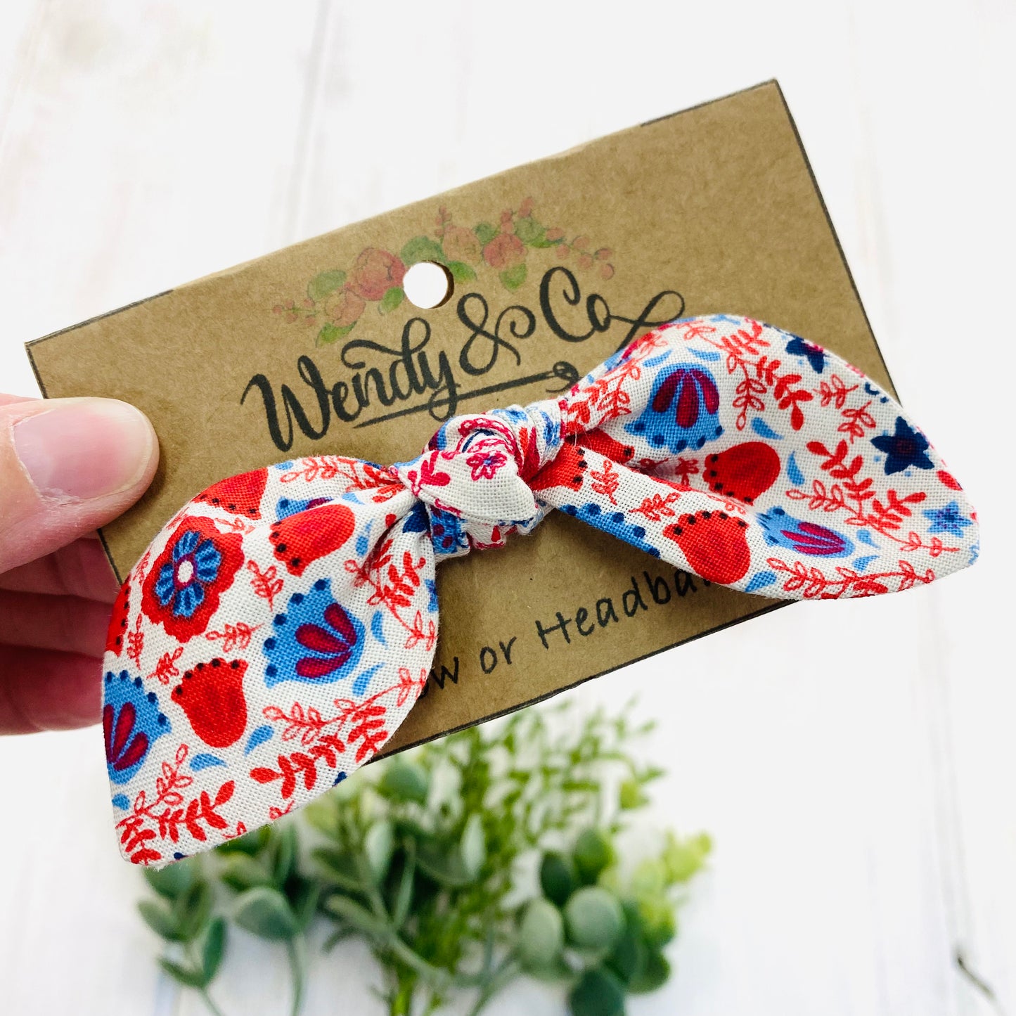 Handmade baby headband in floral blues and reds.