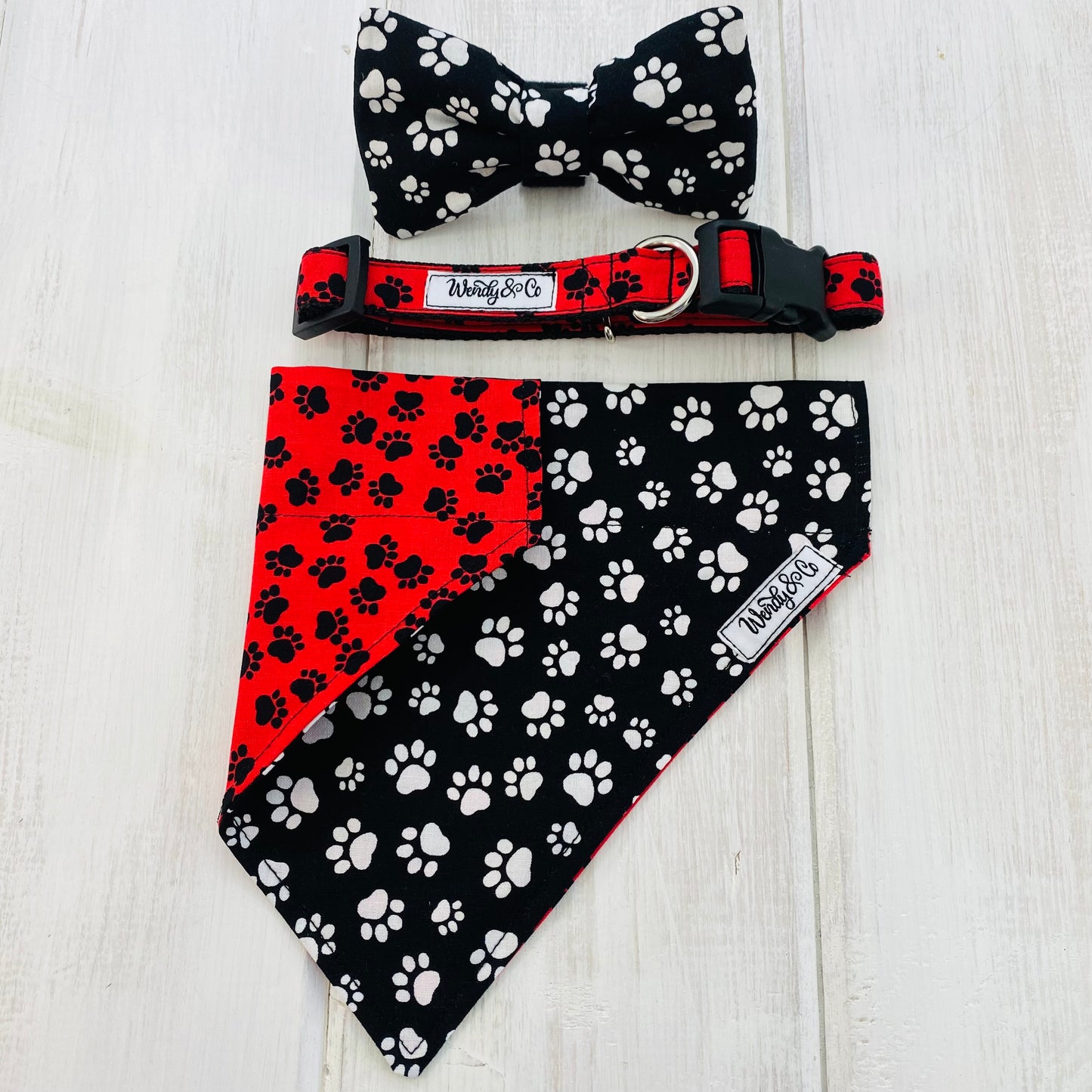 matching Pet bow tie, collar and bandana in clack and white paws.