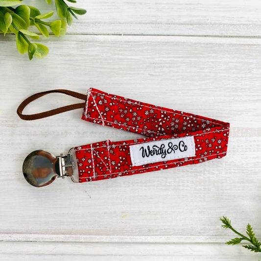 Pacifier clip in maroon floral print.