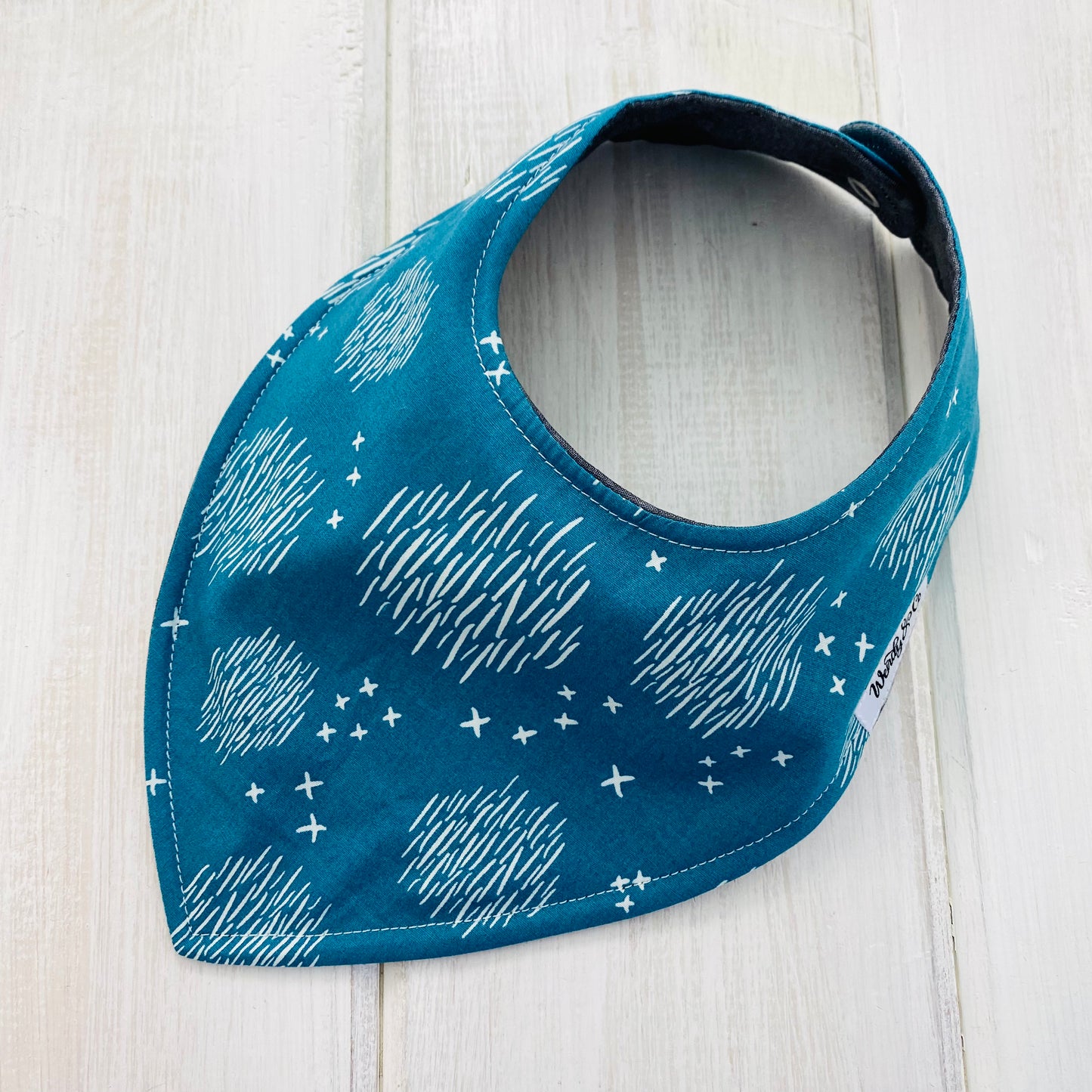 Baby bib, plain smooth front, in neutral teal print