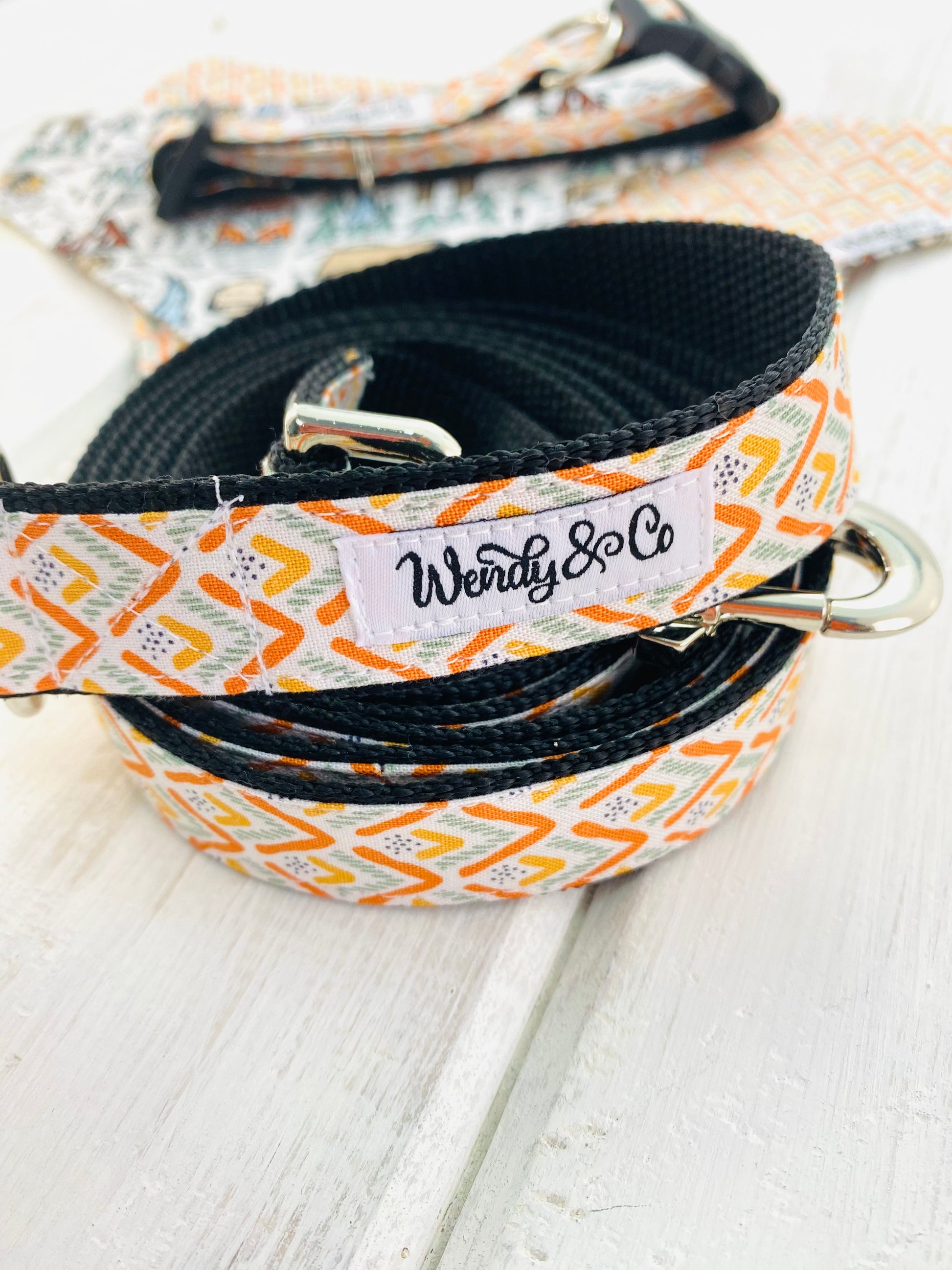 Orange Summit bandana is a modern artwork of orange and olive green mountains on a durable leash.